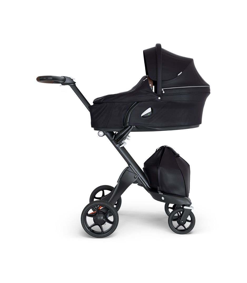 Stokke&reg; Xplory&reg; wtih Black Chassis and Leatherette Brown handle. Stokke&reg; Stroller Carry Cot Black.